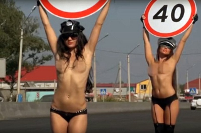 Topless Women Carry Speed Limit Signs For Road Safety Campaign in Russia 
